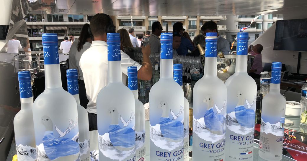 Lined up bottles of Grey Goose vodka in preparation for evening entertainment on board a charter yacht at the Monaco Grand Prix