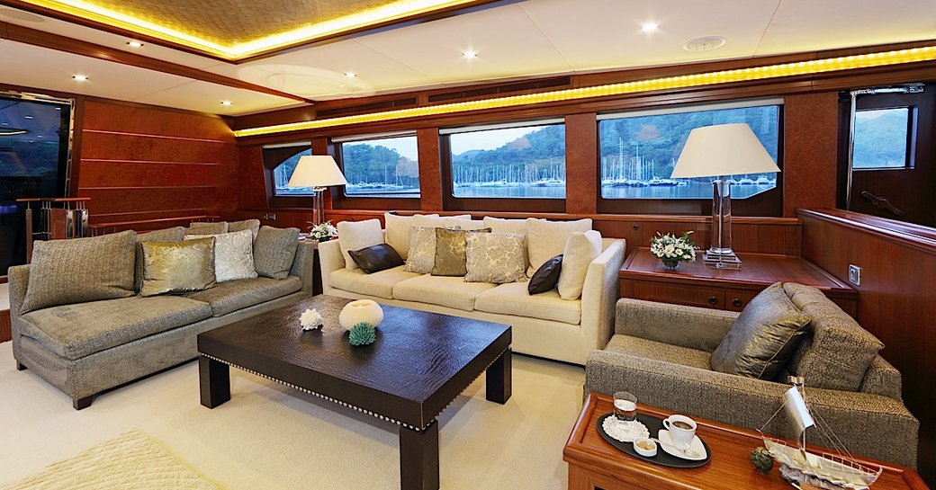 mahogany woodwork and contemporary furnishings in the main salon of charter yacht DAIMA