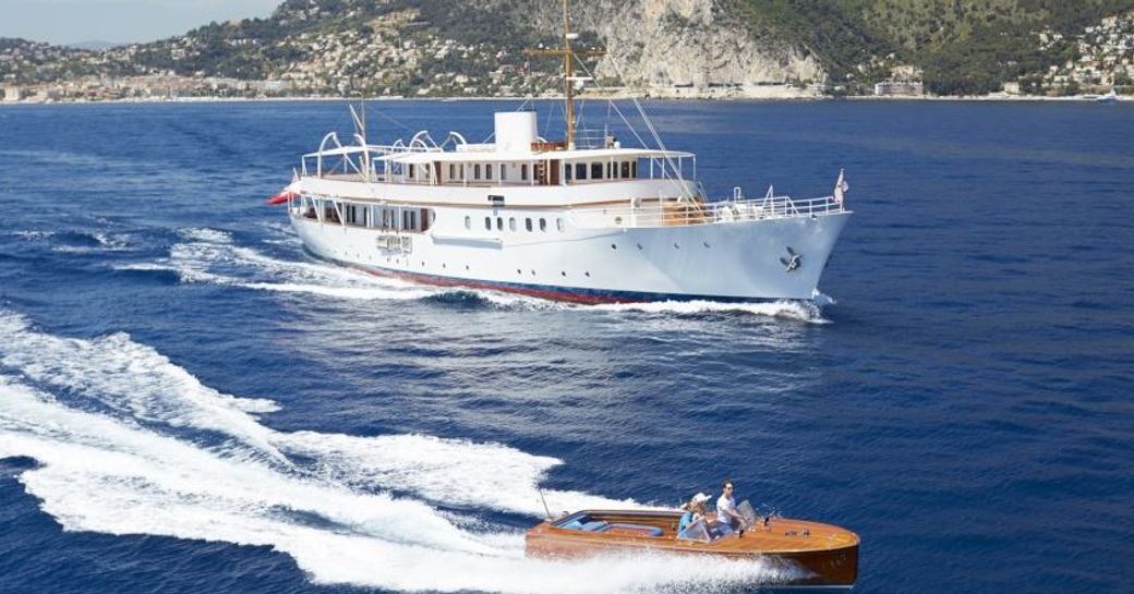 The classically styled motor yacht MALAHNE with the tender used to board her 