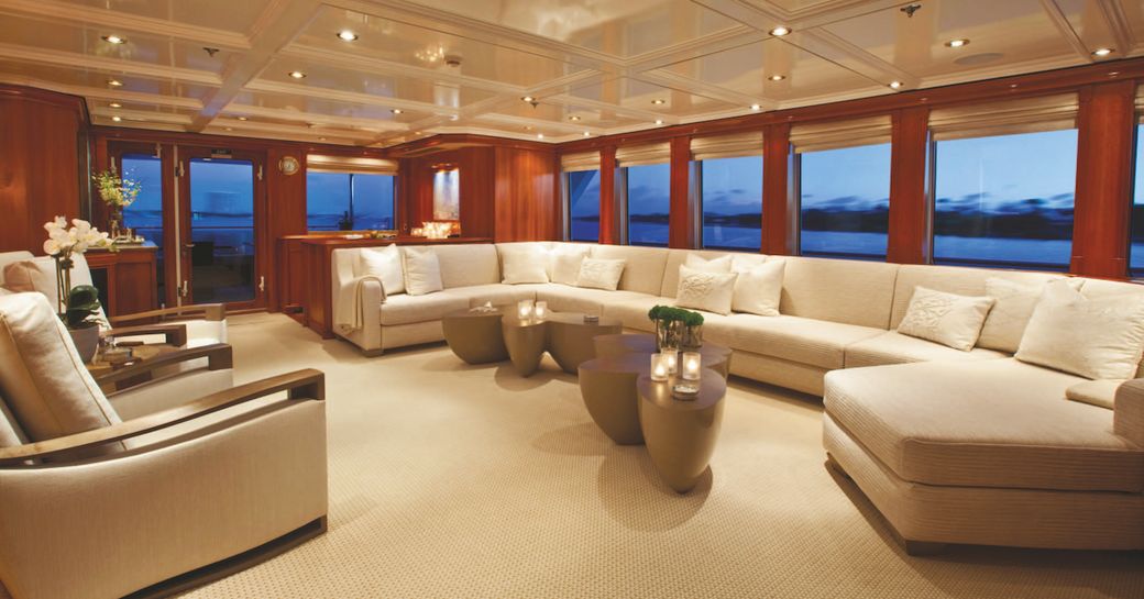 long, curving sofa in the main salon of motor yacht Milk and Honey 