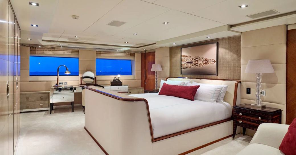 Master cabin onboard charter yacht TIMBUKTU, central forward facing berth with white seating in foreground and two wide windows in the background