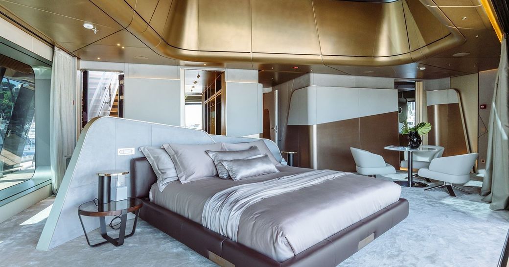 Overview of the master cabin onboard boat charter THIS IS IT, central berth facing forward with seating area aft