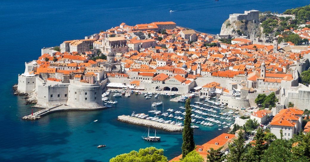 orange-roofed city of Dubrovnik with city walls and harbour