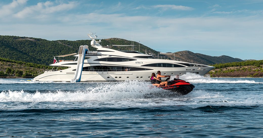 jet skiing is a fun activity for everybody and can be done in the privacy of a secluded cove and right by your luxury charter yacht like these guests are doing on motor yacht AFRICA