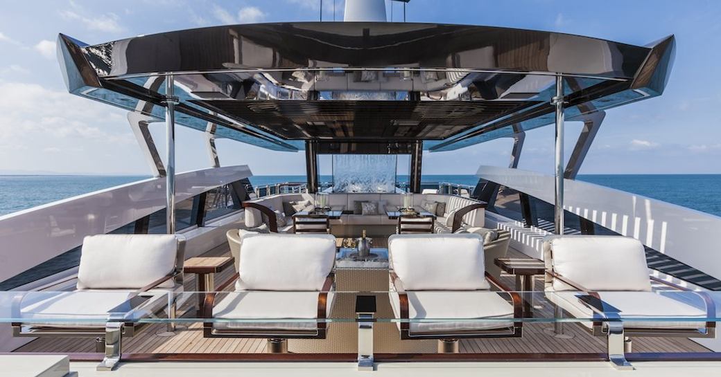 Line of four sunloungers on the sun deck onboard charter yacht PARILLION
