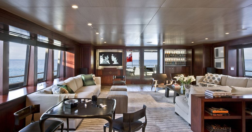sofas and games table in the sophisticated main salon aboard luxury yacht CYAN