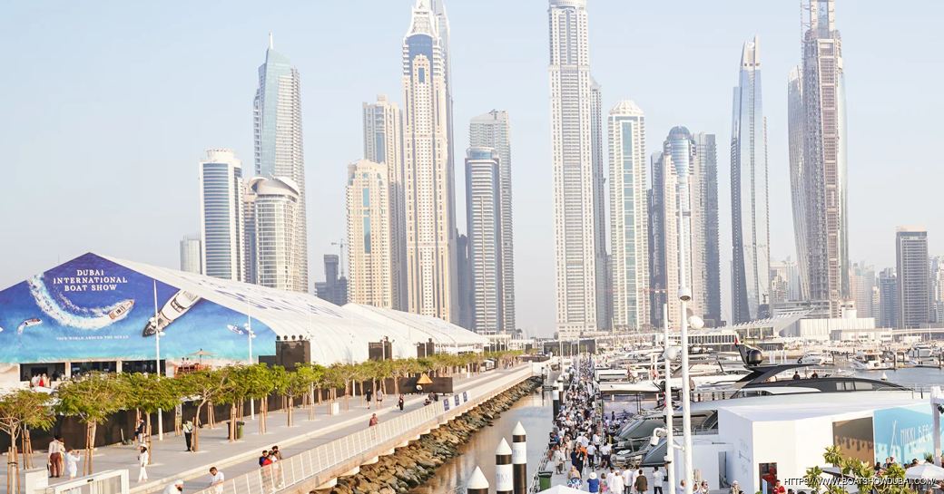 Overview of the Dubai International Boat Show, with motor yachts berthed in the foreground