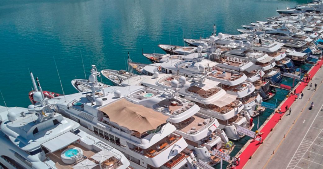 Motor yachts moored in line at the Mediterranean Yacht Show.