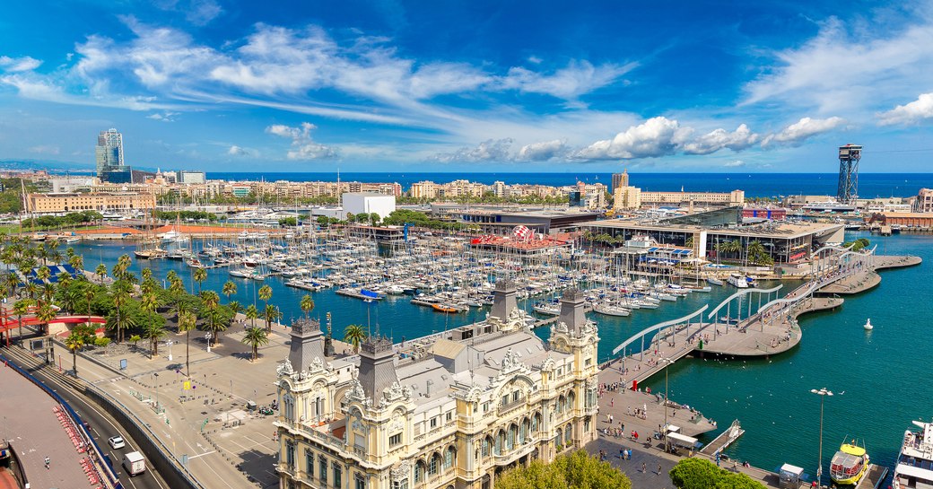 Aerial view of Port Vell Barcelona, many motor yachts berthed in marina.