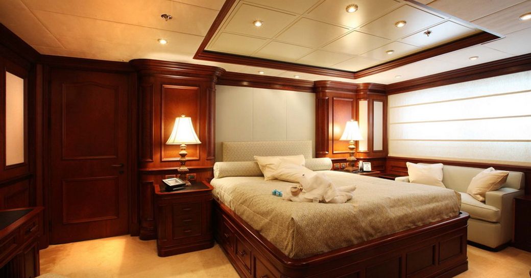 VIP cabin onboard charter yacht NOMAD, central berth facing forward with a wide window and sofa