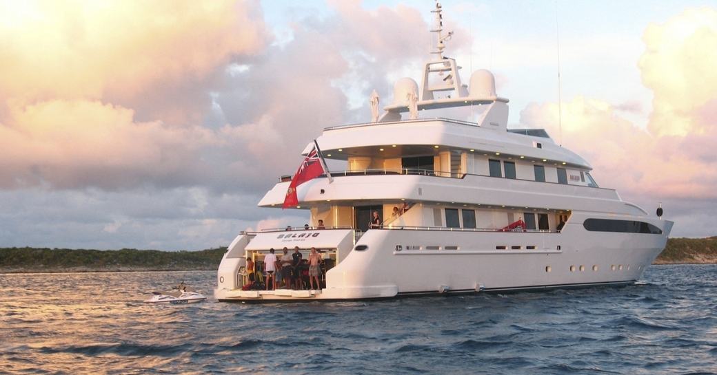 motor yacht BALAJU anchors in the Bahamas on a luxury yacht charter as the sun begins to set