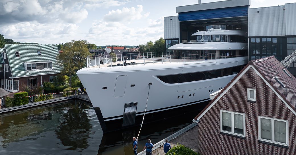 Frontal view of Feadship 'Project 822'  being floated out of her construction shed in Kaag, Netherlands.