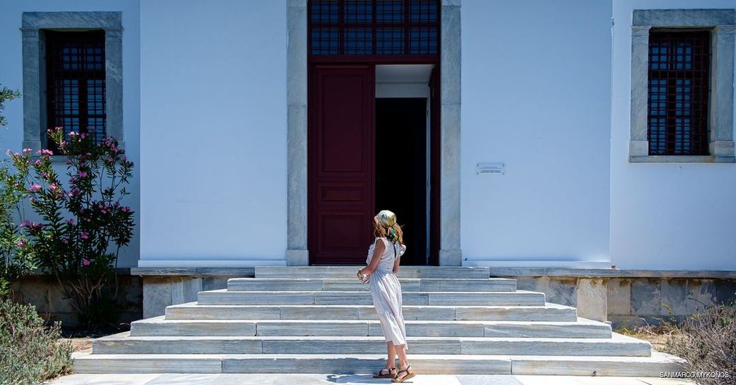 woman standing outside the Archaeological Museum of Mykonos