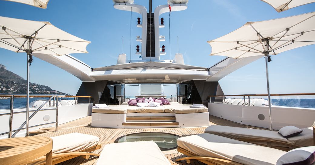 Exteriors onboard private yacht charter ST DAVID, with sunloungers, seating and parasols