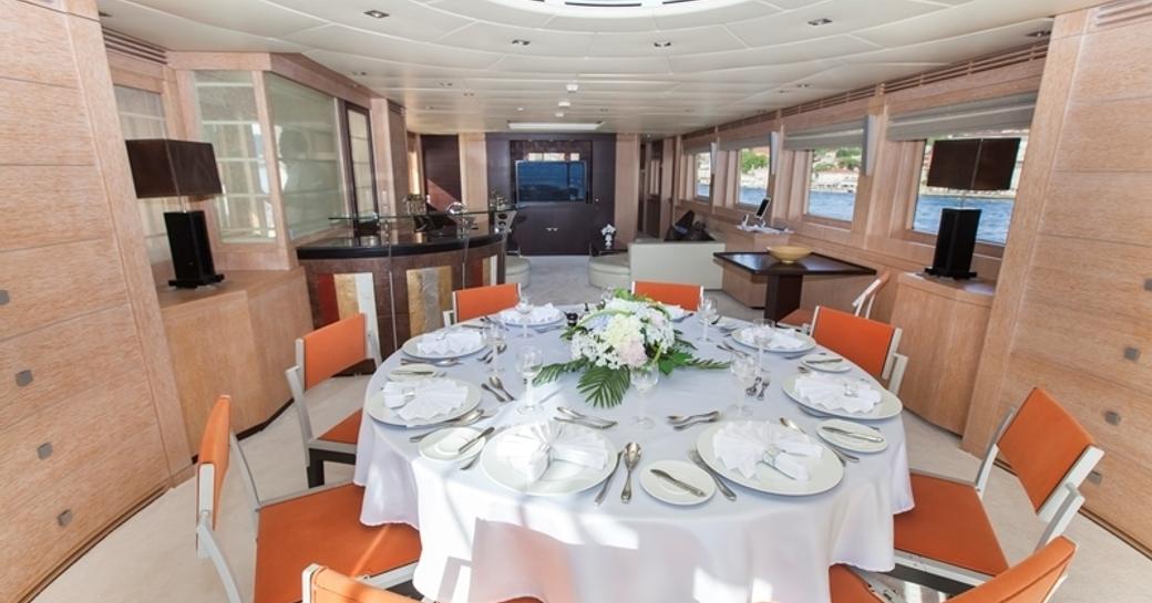 circular dining table in main salon aft of luxury yacht CANPARK 