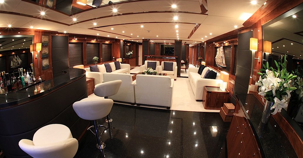 sleek and stylish main salon with bar area aft on board superyacht Barracuda Red Sea