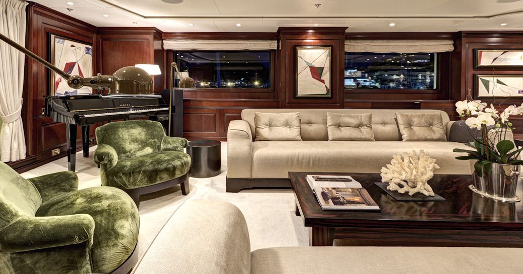 piano and seating area in main salon of luxury yacht Azteca II 