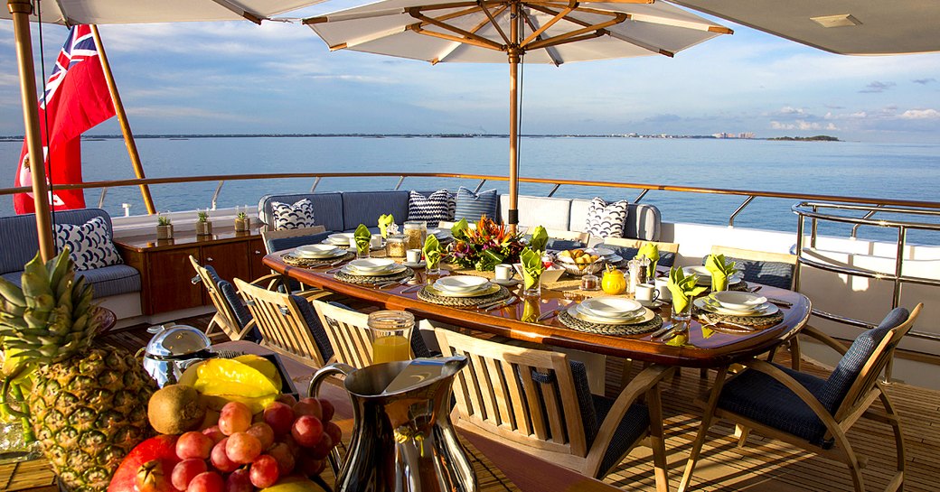 Table laid out with fruit and food on the alfresco deck of superyacht Lady J