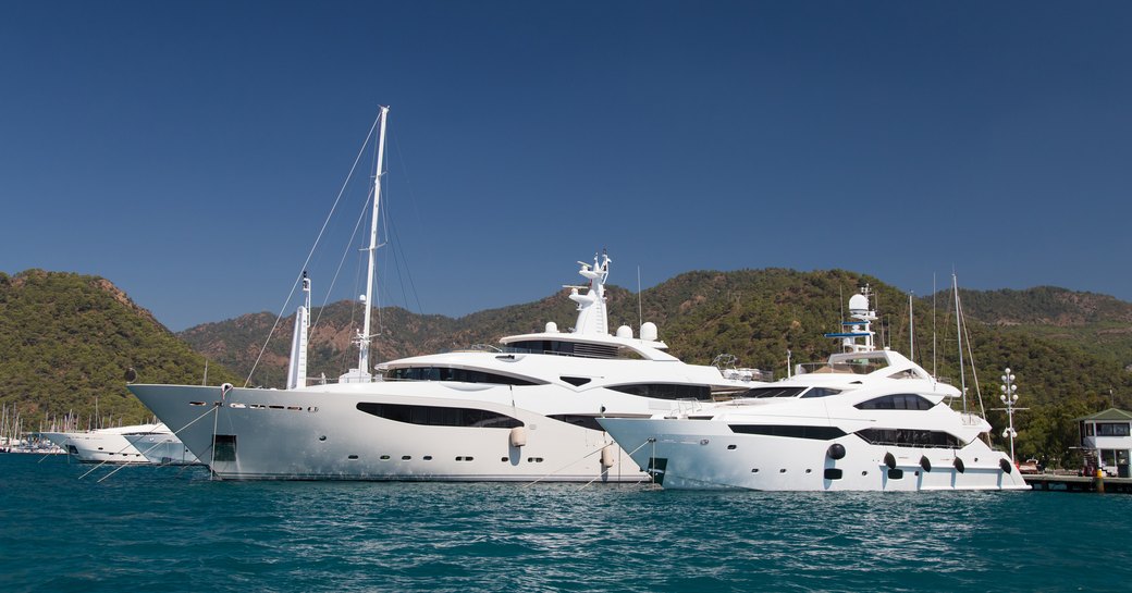 Superyachts berthed on a clear day in Gocek D Marin.