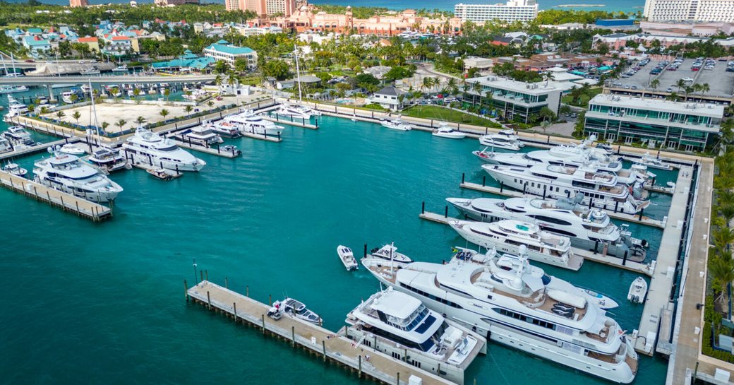 Aerial view looking down over Hurricane Hole Superyacht Marina, with many luxury charter yachts berthed