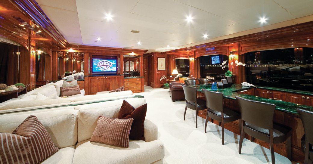 classically styled skylounge with bar and seating areas on board superyacht ‘One More Toy’