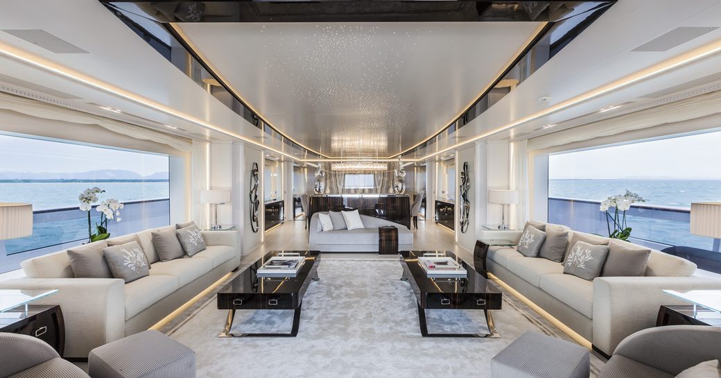 Overview of the main salon onboard charter yacht PARILLION, with extensive lounge space and seating