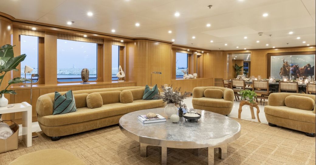 Overview of the main salon onboard charter yacht TREEHOUSE, lounge area in the foreground with dining in the background