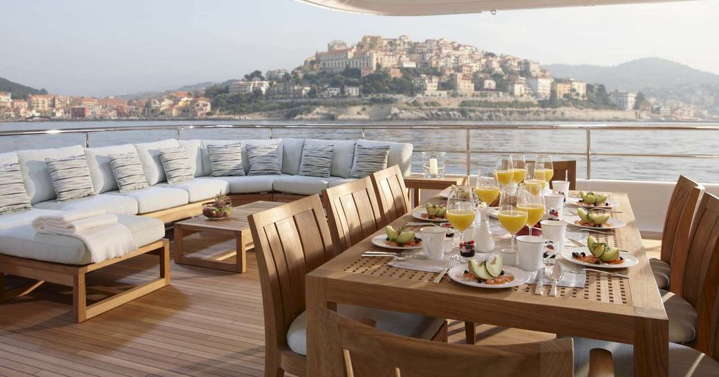 breakfast is served in the al fresco dining area on the upper deck aft of luxury yacht GLADIATOR 