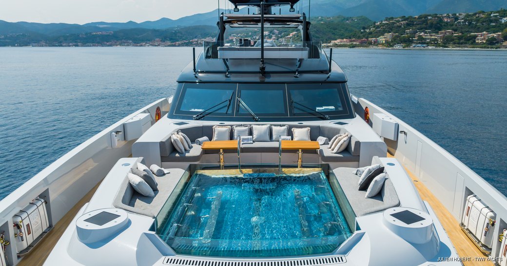 Pool onboard charter yacht GREY, superyacht surrounded by sea.