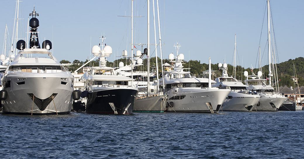 A lineup of motor yachts berthed at the Antigua Charter Yacht Show