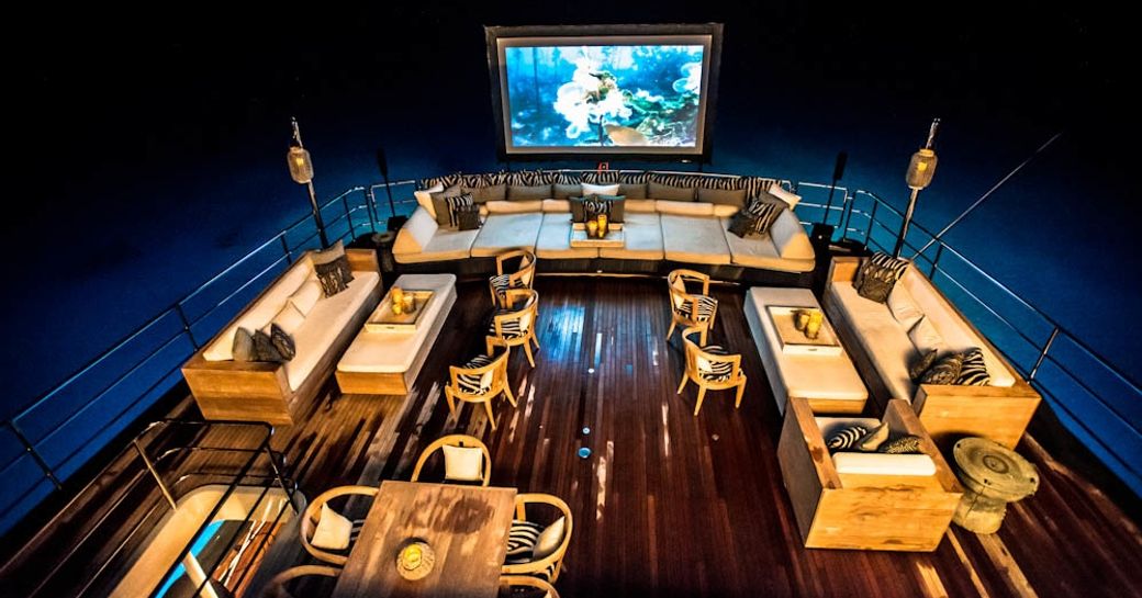 main deck aft aboard luxury yacht  ‘Plan B’ with cinema setup and lounging areas