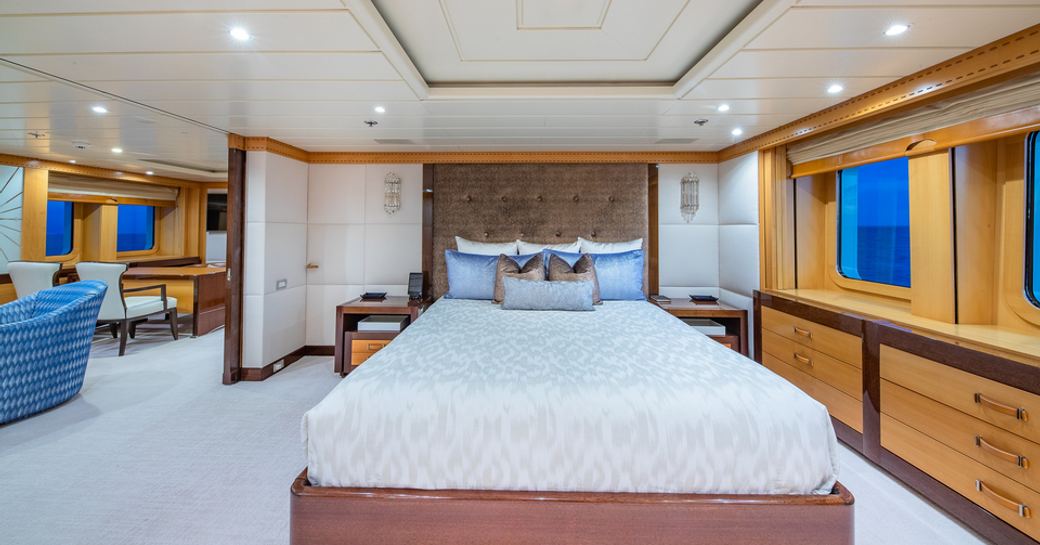 Master cabin onboard charter yacht NITA K II, center berth facing forward with wide windows adjacent