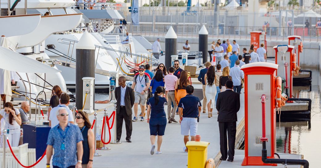 visitors in Yas Marina stroll along the boardwalks alongside berthed superyachts during the Abu Dhabi Grand Prix