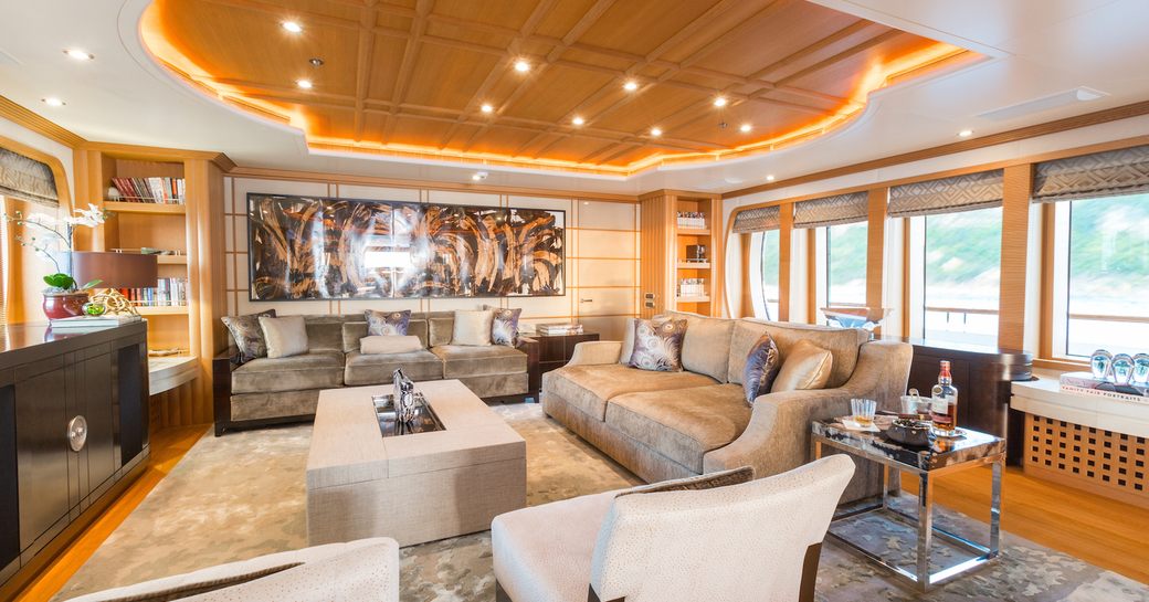 oak-paneled lounge area in the main salon of motor yacht HANIKON 