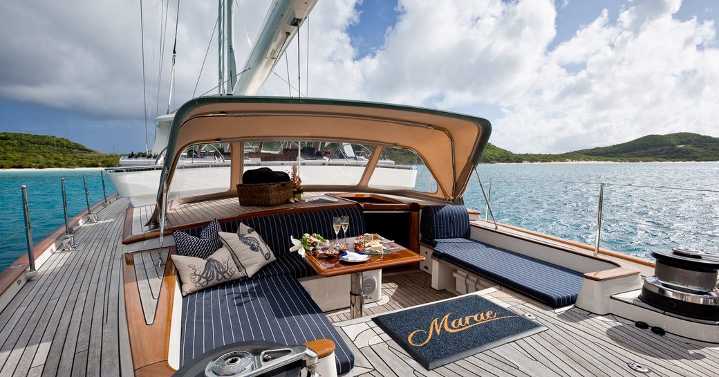 table and l-shaped sofa in aft cockpit of luxury yacht MARAE 