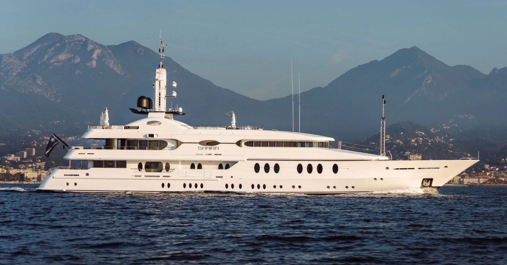 Charter yacht SAMIRA at anchor, with mountains in the background