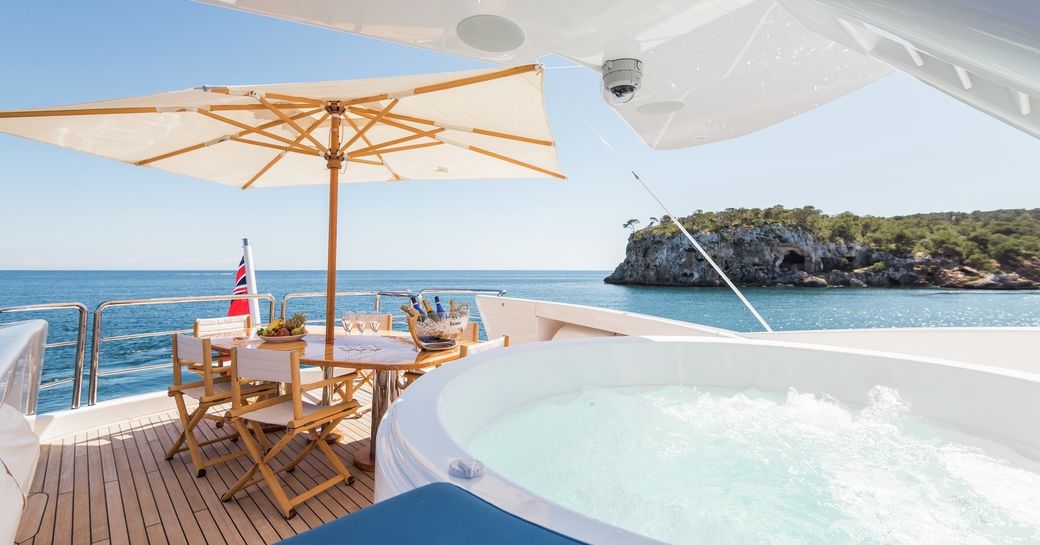 luxury yacht benita blue sundeck with spa pool and dining table