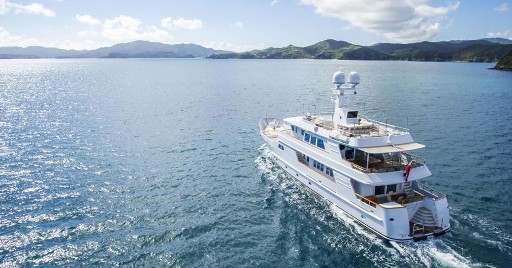 A view of the aft of M/Y RELENTLESS as she cruises towards an island