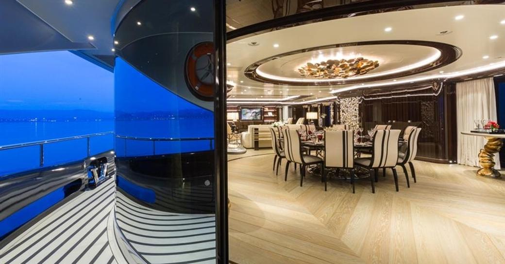 dining room with curved glass doors on main deck aft on board superyacht OKTO 