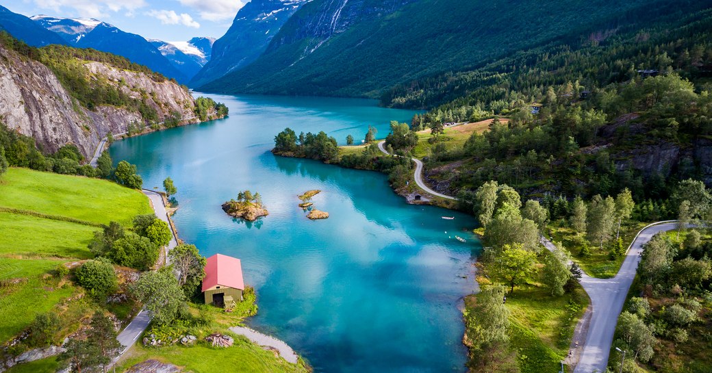 beautiful crystal blue water and green mountains in Norway