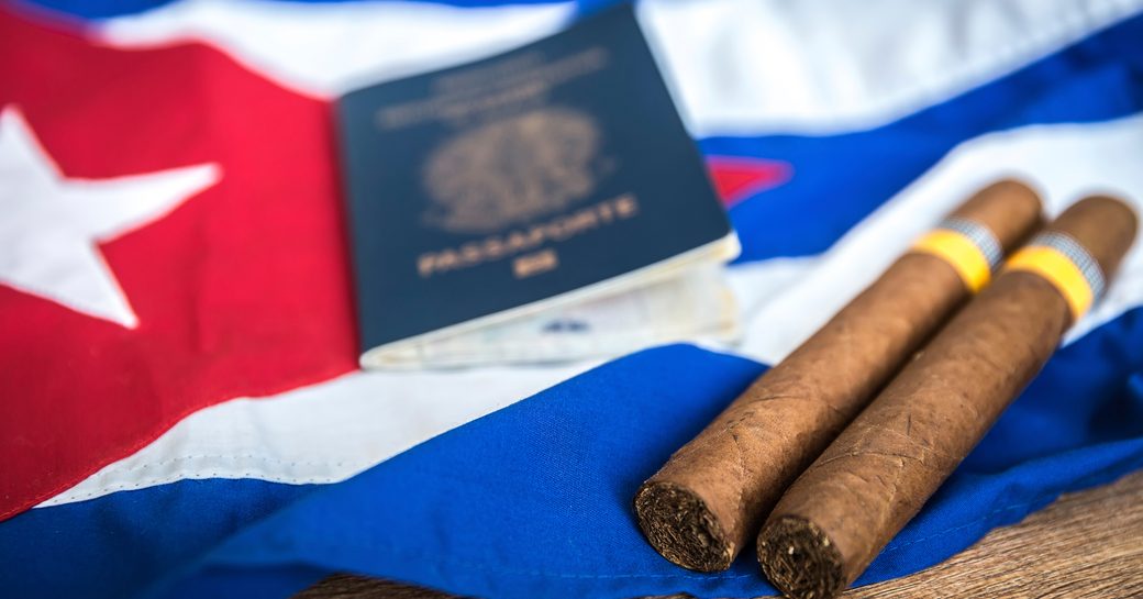 Abstract cuba image with cigars, a Cuba flag, and two cigars