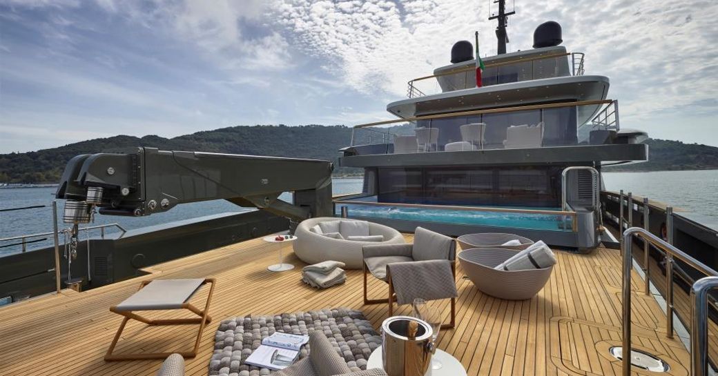 Main aft deck sunning area and crane with pool beyond on expedition yacht MOKA