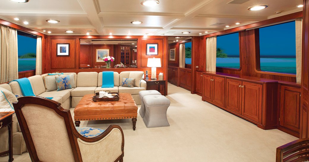 motor yacht Lady J's sleek and classic styled interior salon with turqiose accents and open pan layout