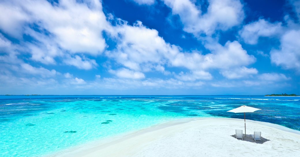 Deserted beach in the Bahamas with azure waters and sky
