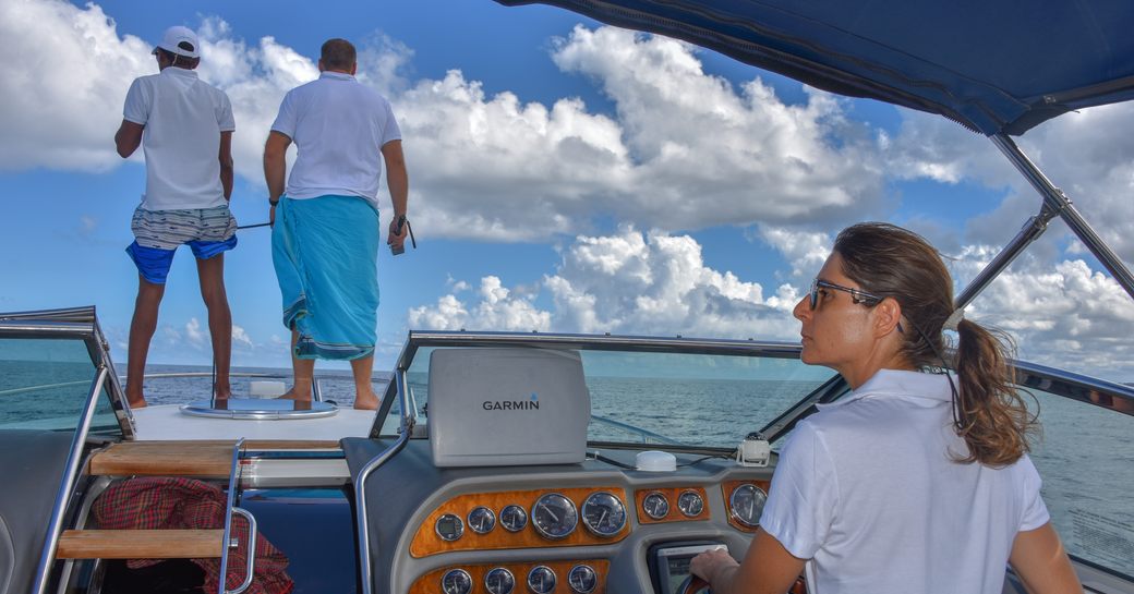 Guests contemplate the waters on a tender driven by crew from the Thanda Island resort, Indian Ocean