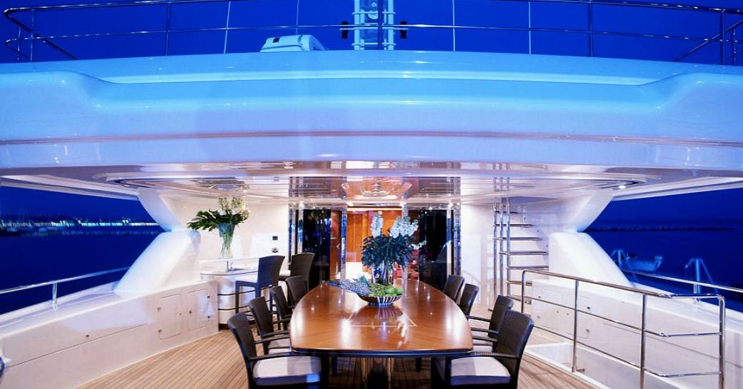alfresco dining at night on upper deck aft of luxury yacht SIMA 