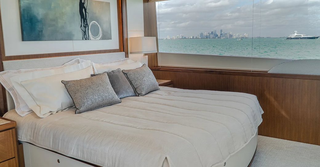 Stateroom with double bed and large window on motor yacht ENTREPRENEUR