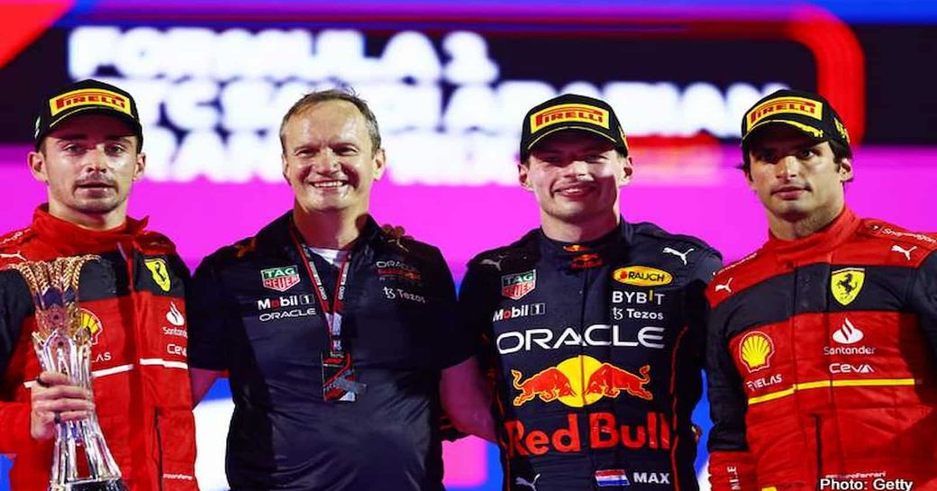 Line up of three winning Formula One winners and host during podium ceremony
