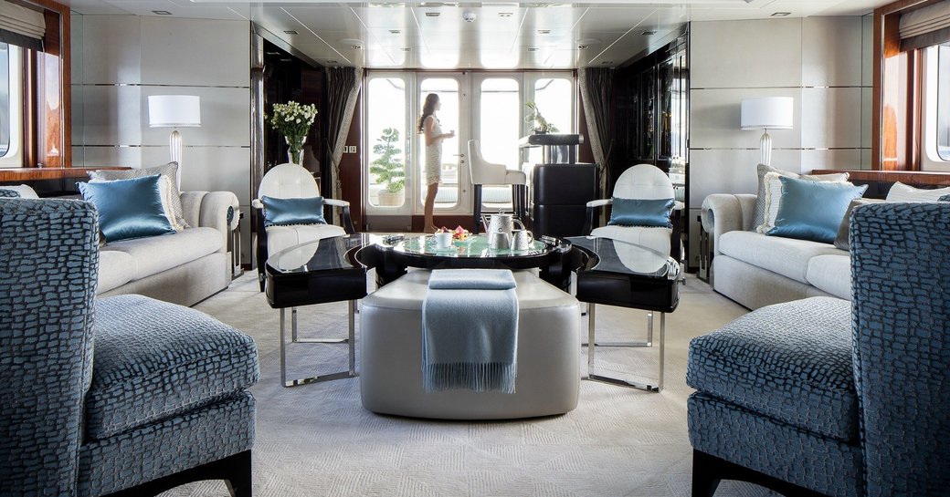 A guest enjoying the main salon of superyacht TURQUOISE