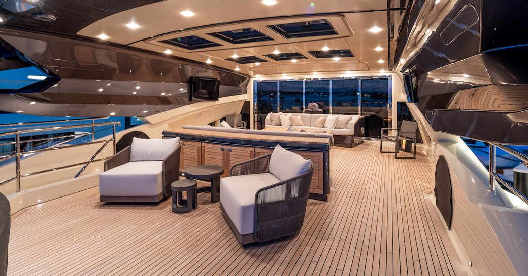 spacious deck and social space onboard luxury charter yacht